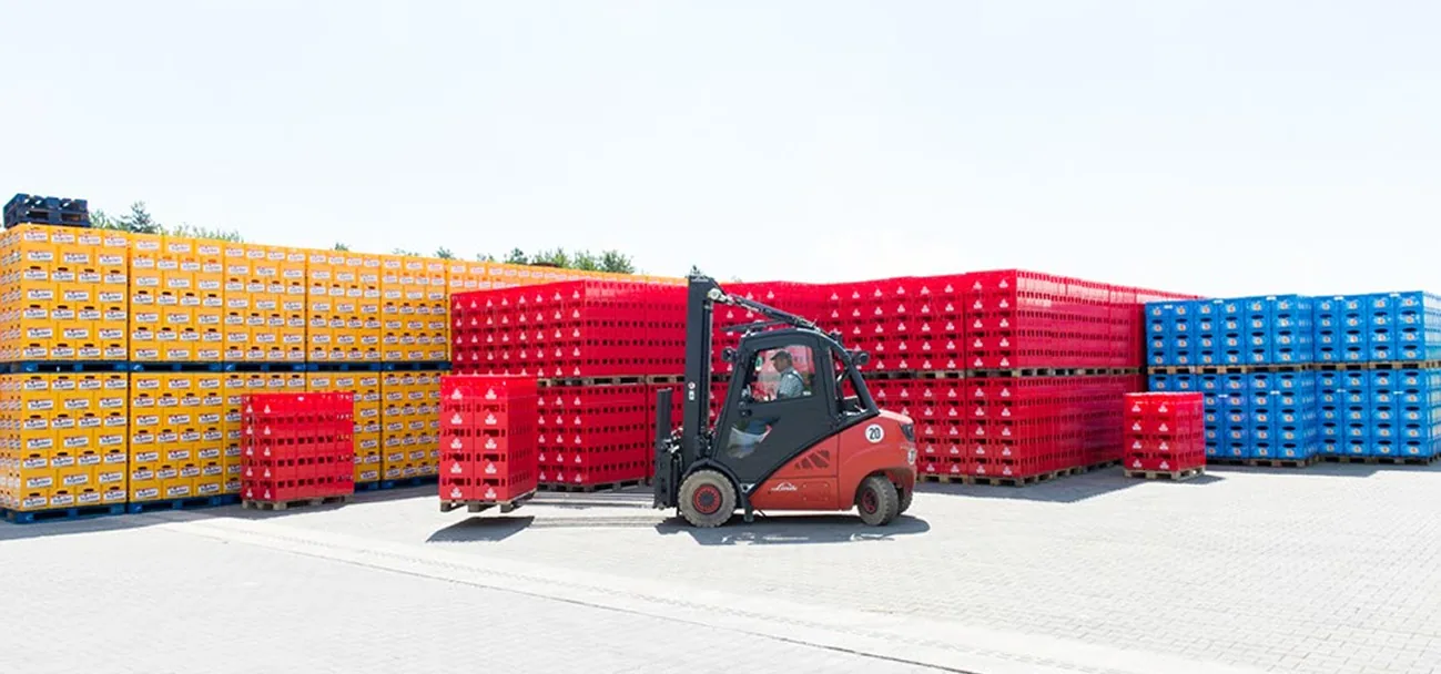 Forklift moving stacked crates